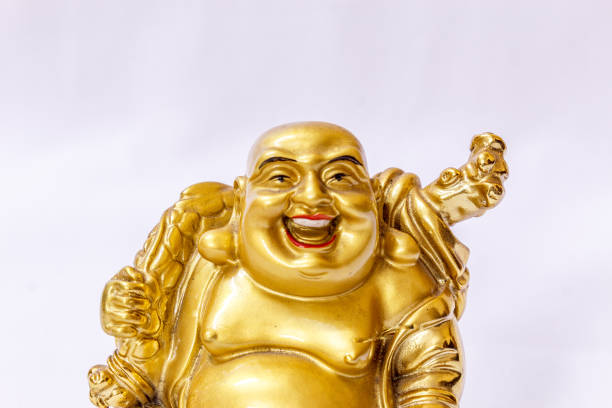 istock Laughing Buddha painted in gold colour with white backdrop 840068582