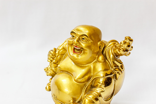 Laughing Buddha painted in gold colour with white backdrop