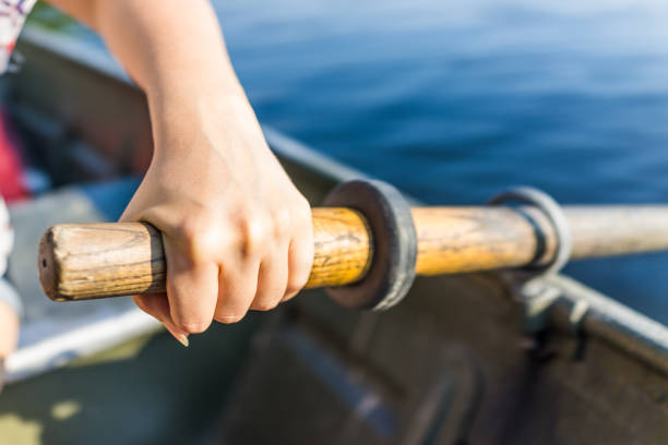 istock Female hand on row boat oar closeup in summer with water 840077364