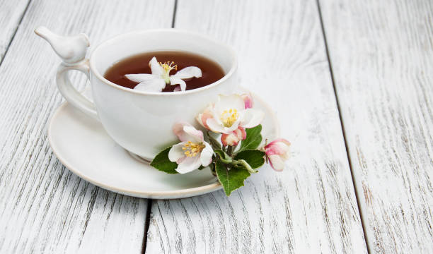 istock cup of tea with apple blossoms 840078280