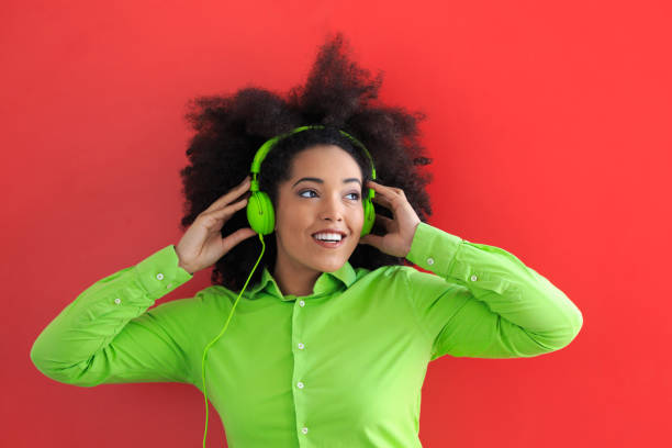 istock Afro woman with green headphones 840082676