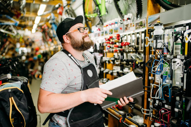 istock Bicycle mechanic with notebook in bike shop 840085400