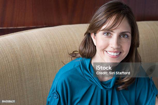 Smiling Business Woman In Booth Stock Photo - Download Image Now - 40-44 Years, Women, Business