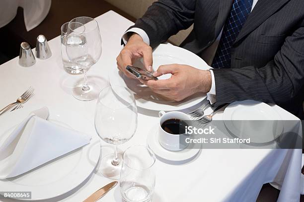 Man Typing On Cell Phone In Restaurant Stock Photo - Download Image Now - High Angle View, Tablecloth, 40-44 Years