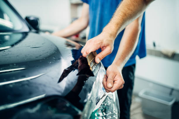 istock Worker hands wraps car hood in protective coating 840088870