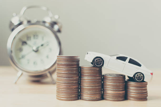 White miniature car on money coin stack growth with clock White miniature car on money coin stack growth with clock cash for cars stock pictures, royalty-free photos & images