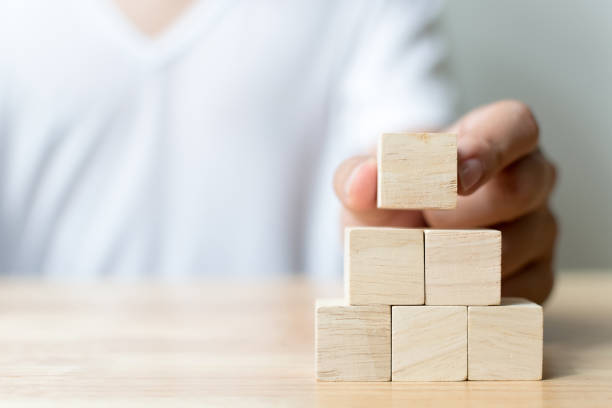 istock Hand arranging wood block stacking as step stair. Business concept for growth success process 840092472