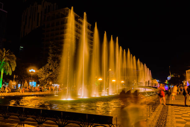 istock people looking at Fountain with night light 840094536