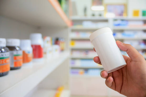 istock pharmacist with medicine bottle at the pharmacy 840094964