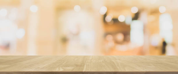 istock Wood table top and blurred abstract background from interior building banner background - can used for display or montage your products. 840102244