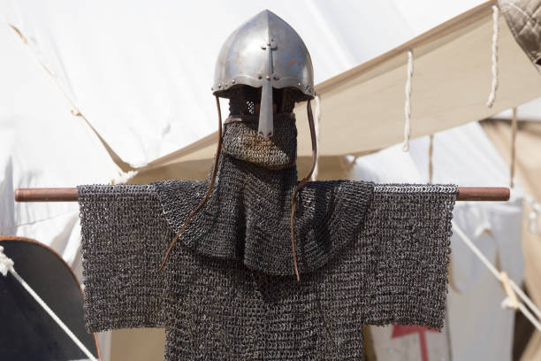 Medieval knight helmet and chain mail hanging in front of tent photo is taken with dslr camera at some European traditional medieval festival chain mail stock pictures, royalty-free photos & images