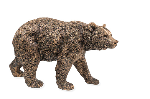 Beautiful bronze figurine of a large brown bear isolated on white background