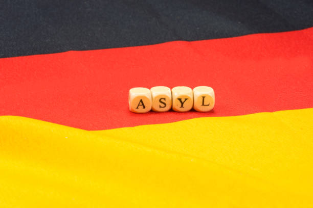 istock Flag of Germany and the word asylum 840105982
