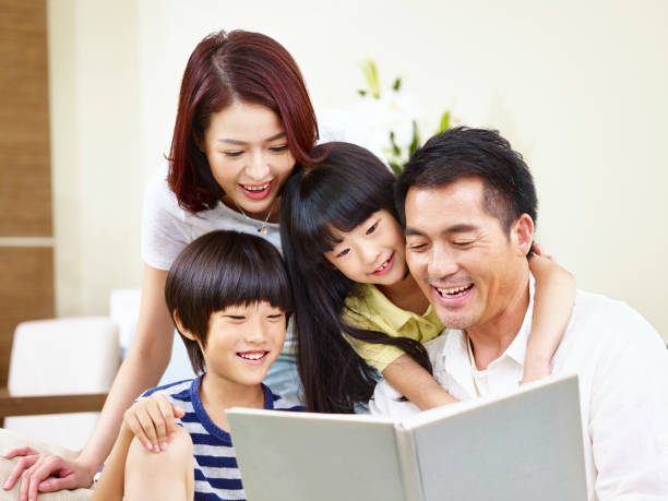 istock happy asian family reading a book together 840106432