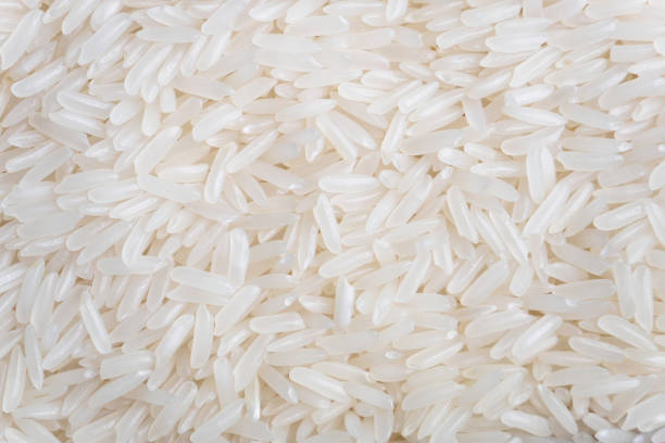 Thai Jasmin rice grains close up background Thai Jasmin rice grains close up background jasmine rice stock pictures, royalty-free photos & images