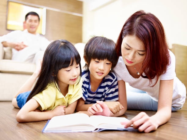 istock asian mother and two child reading book 840109678