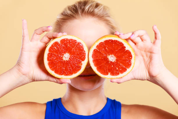 istock Woman holding grapefruit citrus fruit in hands 840109900