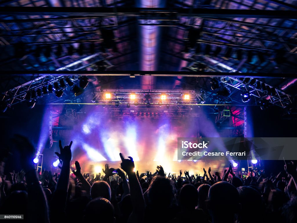 Concert crowd clapping Concert hall crowded with fans. Stage - Performance Space Stock Photo