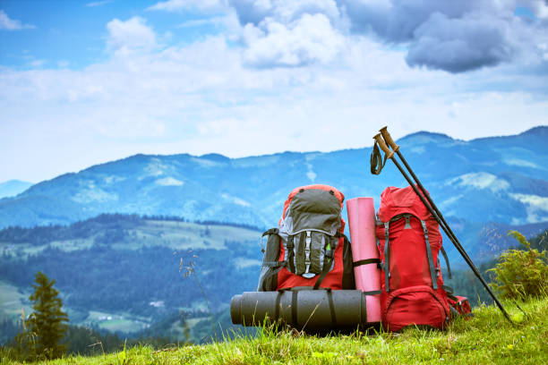 istock Backpacks in the mountains overlooking the mountains on the green grass. 840113520