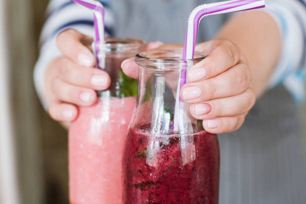 istock Waiter proposes fresh smoothie to somebody 840116980