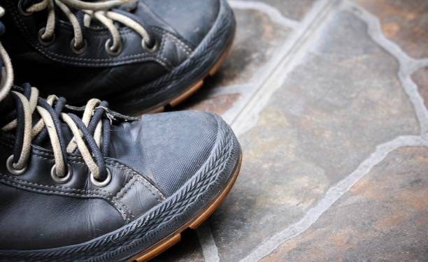 istock A pair of fashion boots on tile floor. Top view, empty space 840117028