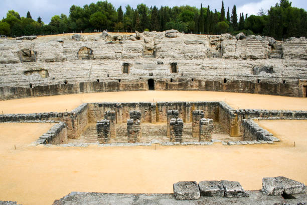 Roman amphitheatre at Italica, Andalusia, Spain The ruins of the Roman amphitheatre at Italica, an ancient city in Andalusia, Spain italica spain stock pictures, royalty-free photos & images