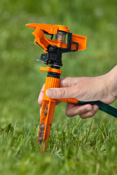 istock hand installing garden sprinkler for irrigation 840117202