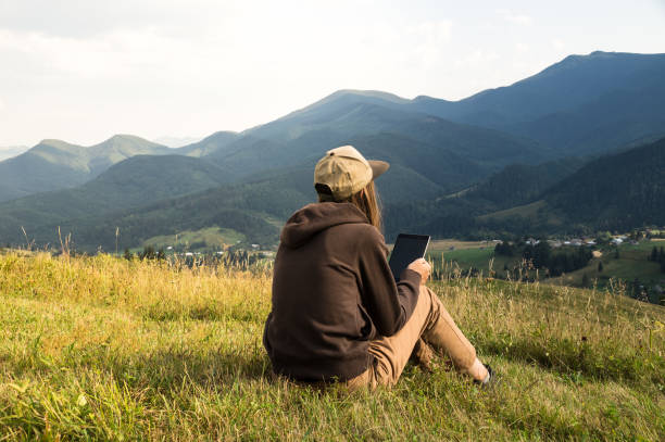 istock Girl works with laptop computer in mountain during vacation 840117874