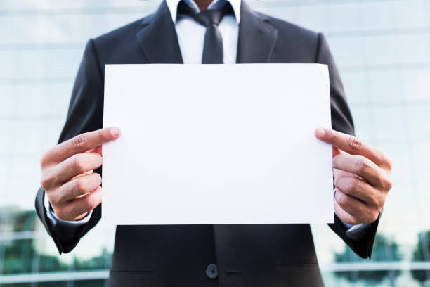 istock Anonymous businessman or worker standing in suit with paper. 840125338