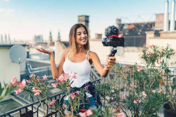 istock Smiling woman vlogging at rooftop terrace 840128348