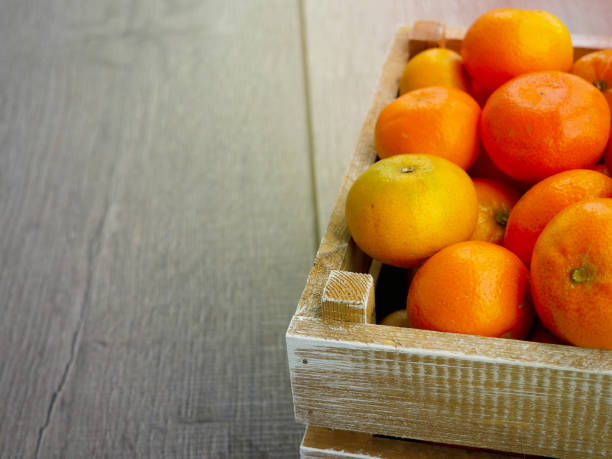 istock box of tangerines on wooden background 840131724