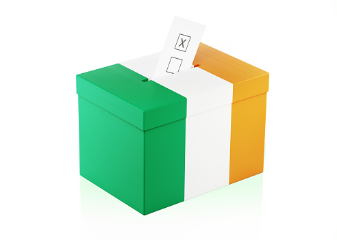 Ballot box textured with Irish Flag. Isolated on white background. A vote envelope is entering into the ballot box. Horizontal composition with copy space. Great use for referendum and 2018 presidential elections related concepts. Clipping path is included.