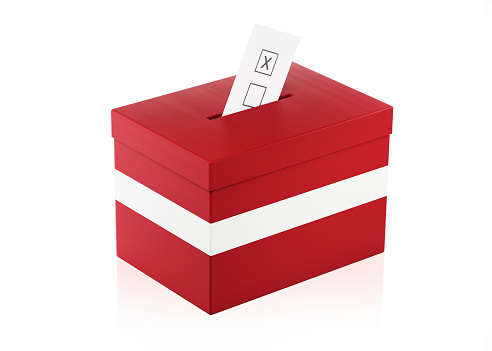 Ballot box textured with  Latvian Flag. Isolated on white background. A vote envelope is entering into the ballot box. Horizontal composition with copy space. Great use for referendum and 2018 presidential elections related concepts. Clipping path is included.