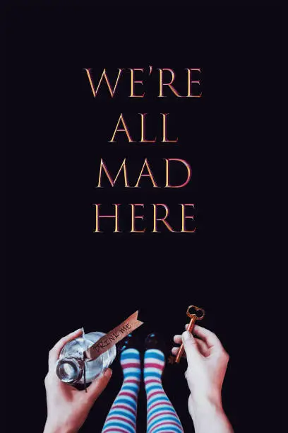 Wonderland background. A key and a potion in hands. We are all mad here.