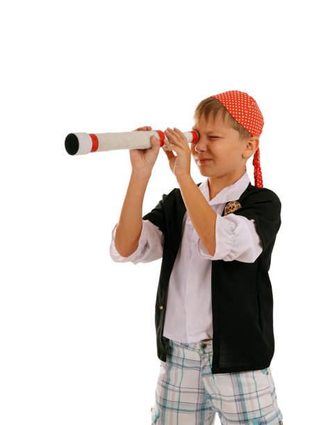 istock Studio portrait of young boy dressed as pirate with spyglass 840142226