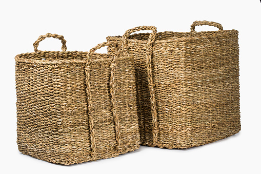 SET OF TWO LARGE RECTANGULAR NATURAL PLANT FIBRE BRAIDED BASKET WITH HANDLES  ISOLATED ON WHITE BACKGROUND