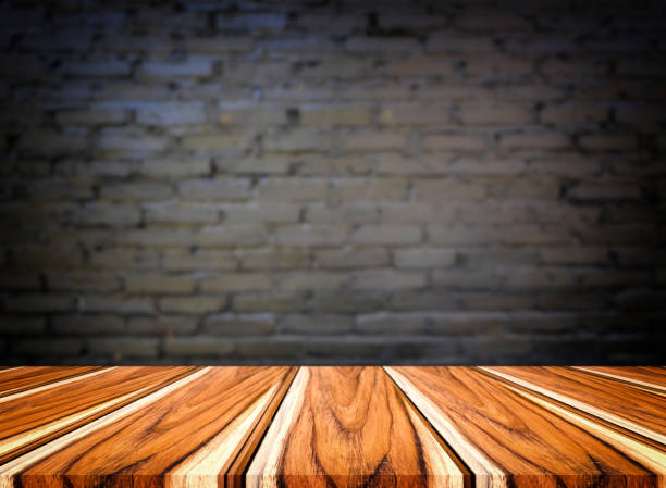 istock Selected focus empty brown wooden table and wall texture or old black brick wall blur background image. for your photomontage or product display 840144472