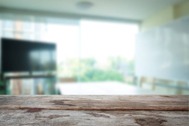 istock Selected focus empty old wooden table and meeting room or office work blur background image. for your photomontage or product display 840144486