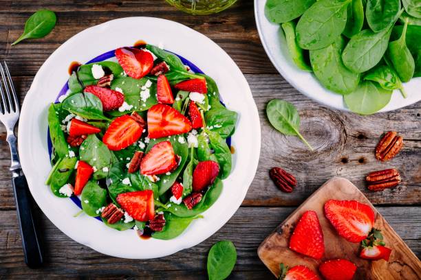 istock Spinach salad with strawberries, feta cheese, balsamic and pecan nuts 840146900