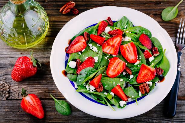 istock Spinach salad with strawberries, feta cheese, balsamic and pecan nuts 840146946