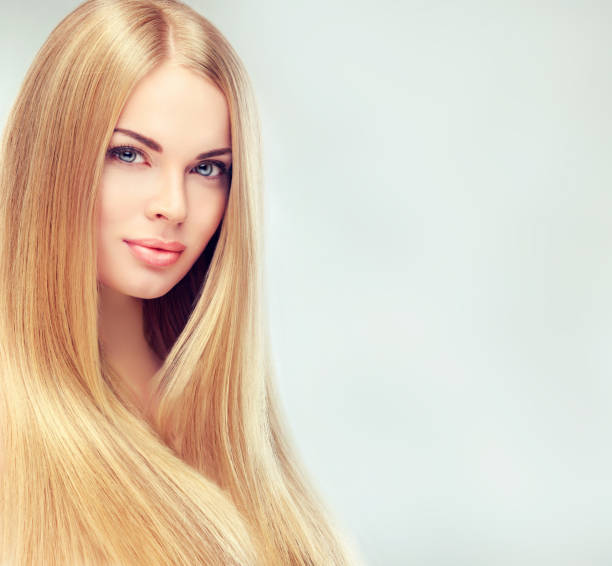 Extremely attractive blonde. Young, blonde haired woman  with long, straight,shiny hair. stock photo