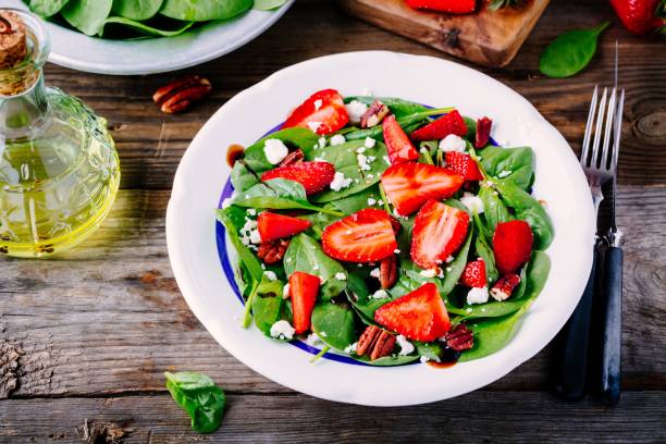 istock Spinach salad with strawberries, feta cheese, balsamic and pecan nuts 840147030