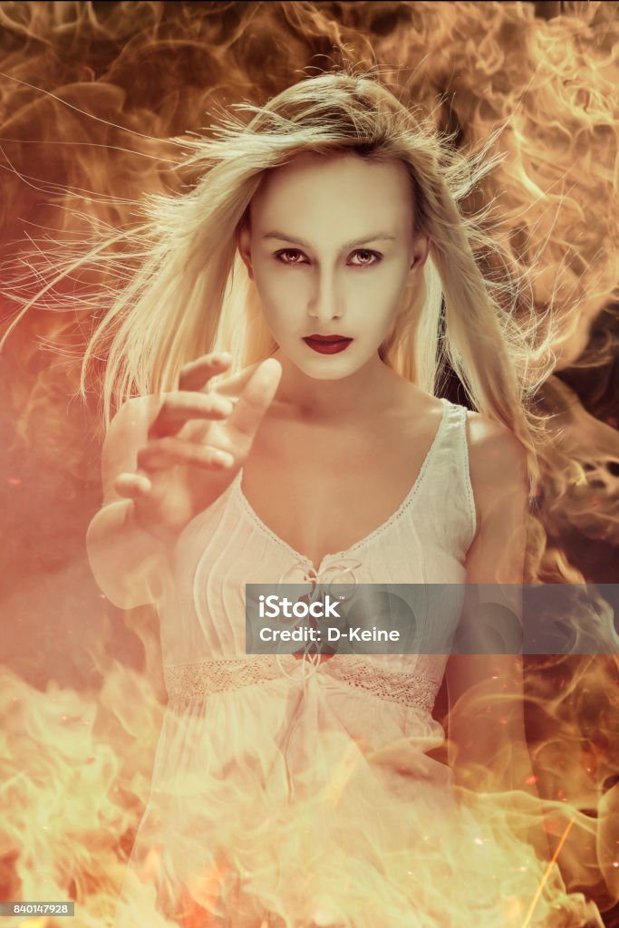 Witch Portrait of a beautiful witch in fire Burning Stock Photo