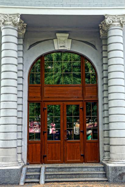 istock Wooden glazed doors on the wall of an ancient building 840151394