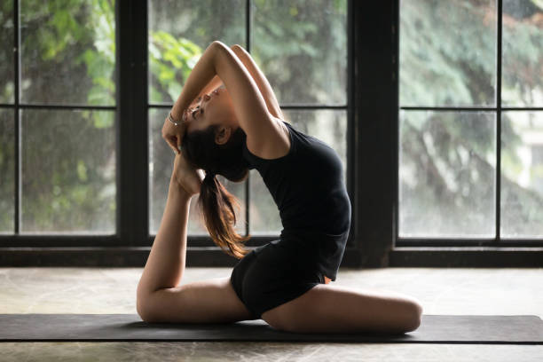 istock Young attractive woman in One Legged King Pigeon pose, studio 840155450