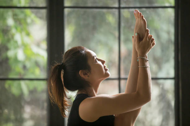 istock Young attractive smiling woman in urdhva mukha paschimottanasana pose, studio 840155466
