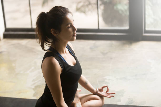 istock Young attractive woman in Lotus pose, studio background 840155486