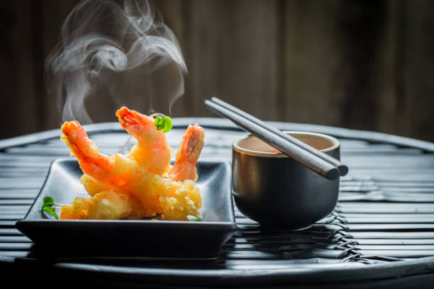 istock Golden shrimp in tempura with red sauce on dark background 840159934