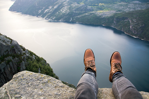 Sitting at the edge of Preikestolen, Norway