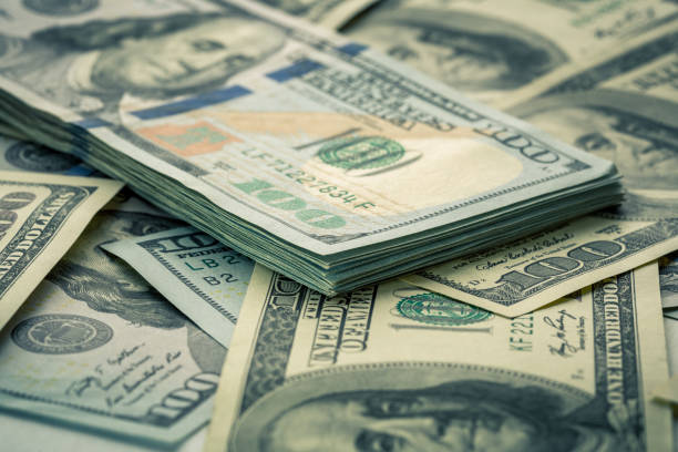 istock Lot of one hundred dollar bills close-up background 840166026